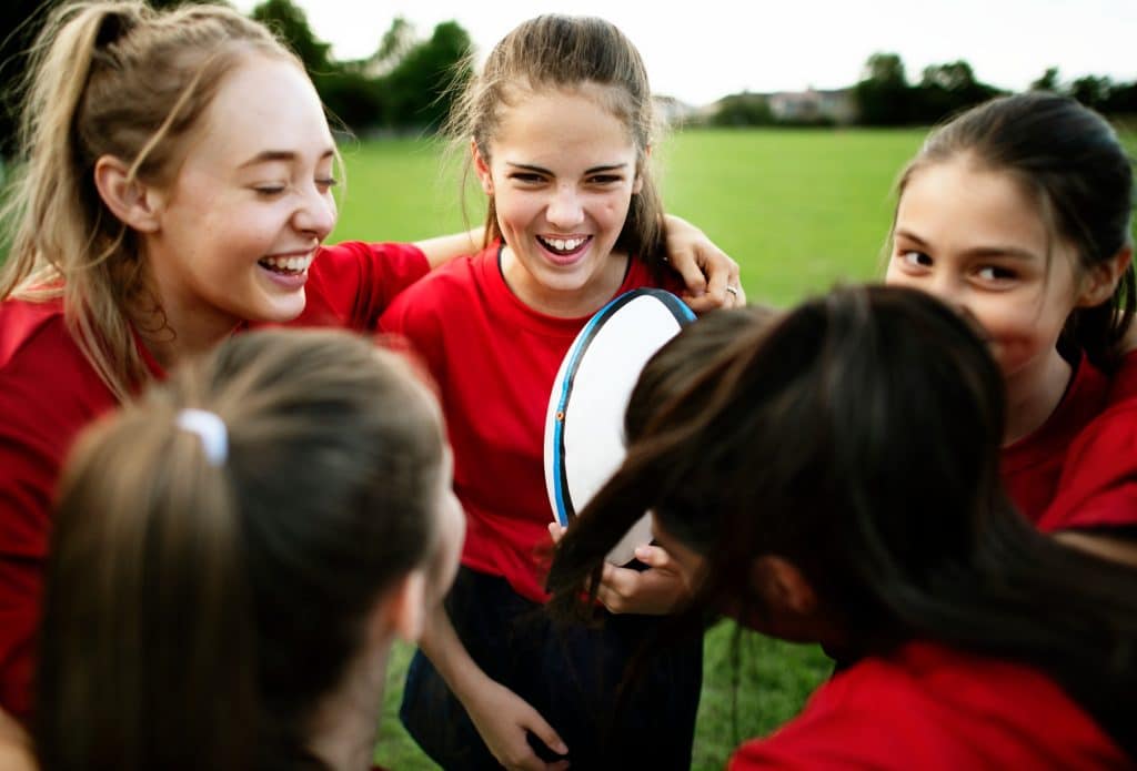 Cheerful young rugby players on the field Cheerful young rugby players on the field