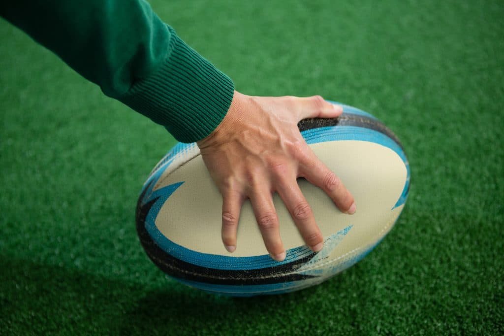 Cropped hand holding rugby ball