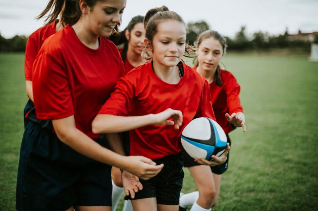 Female rugby players in action on the field
